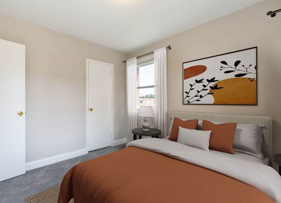 A bedroom with a large bed and a painting on the wall.