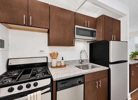 A modern kitchen with a black oven and a white stove.