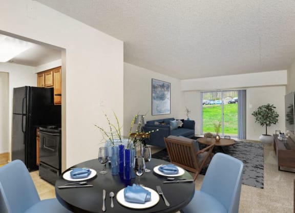 a dining room table with blue chairs in front of a living room