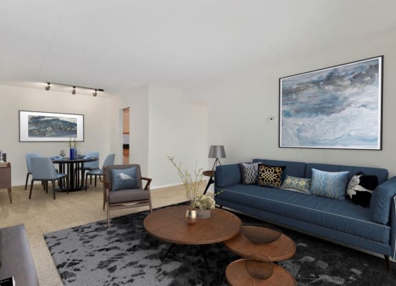 a living room with a blue couch and a table