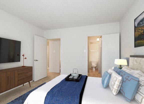 a bedroom with a large bed and a tv