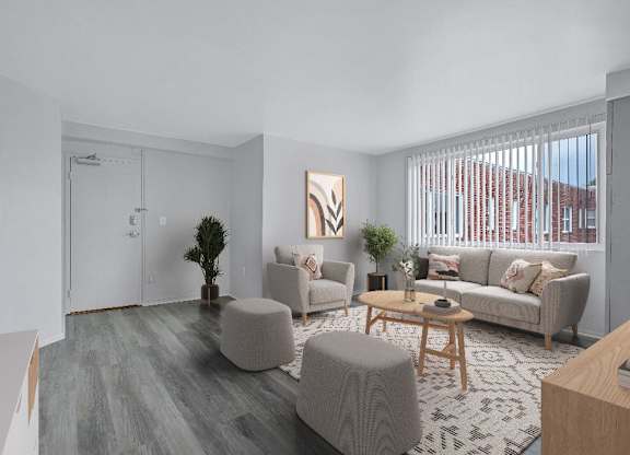 A living room with a grey couch, a wooden coffee table, and a painting on the wall.