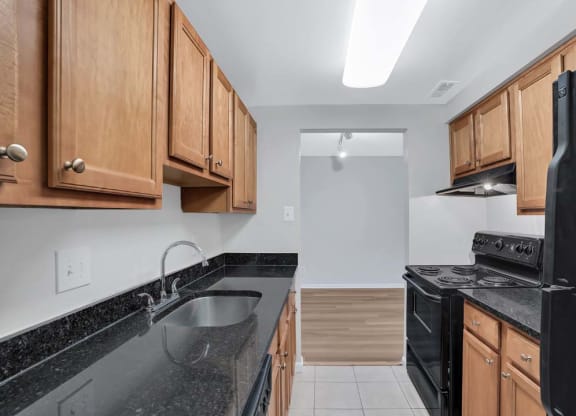 a kitchen with black appliances and wooden cabinets
