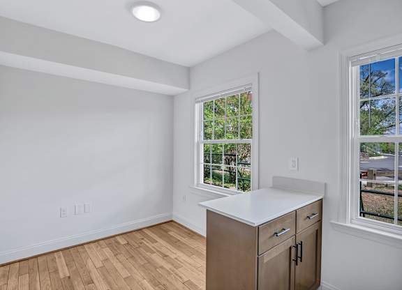 A room with a window and a cabinet.