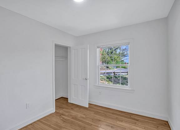 A room with a window and a door.