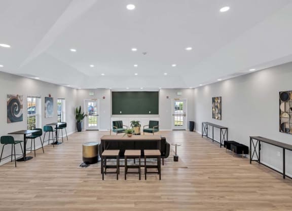 a large room with a large table and chairs and a blackboard on the wall