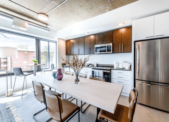 Kitchen and dining area with table and chairs.