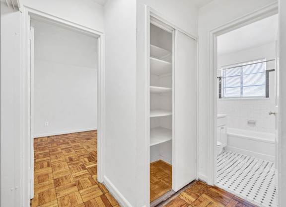 A room with a wooden floor and a white door.