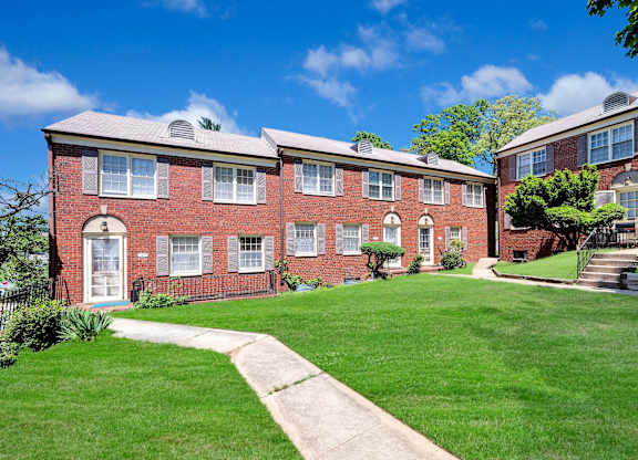 A red brick building with a white door and windows.