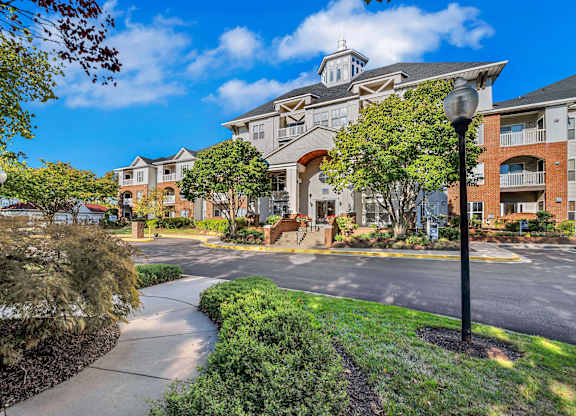 A sunny day at a residential area with apartment buildings and a clear blue sky.