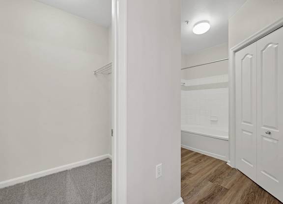A white hallway with a door on the right.