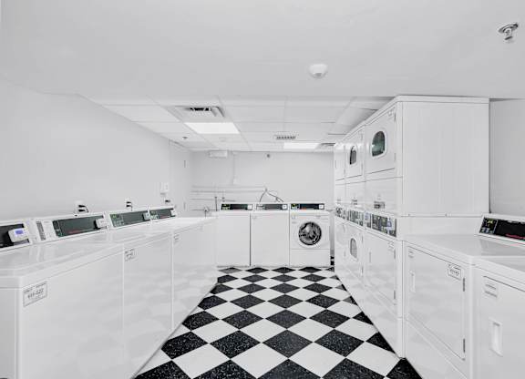 the kitchen has a checkered floor and white appliances