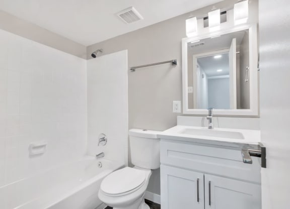 a white bathroom with a sink and a toilet