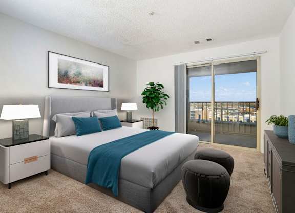 A bedroom with a large bed and a view of the city.