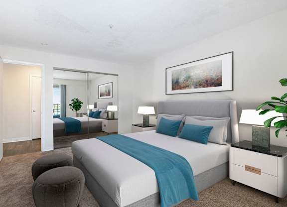 A bedroom with a large bed and a mirror on the wall.