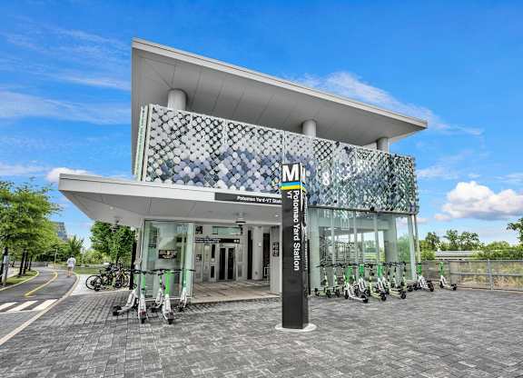 A modern building with a glass facade and a white roof.