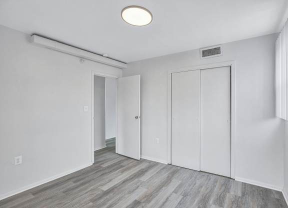 A room with a grey floor and white walls.