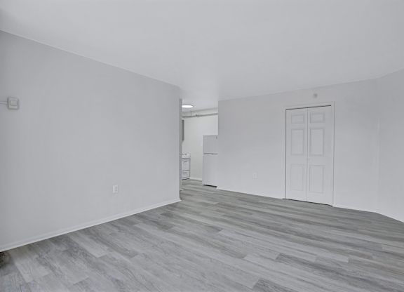A room with a white door and a white cabinet.