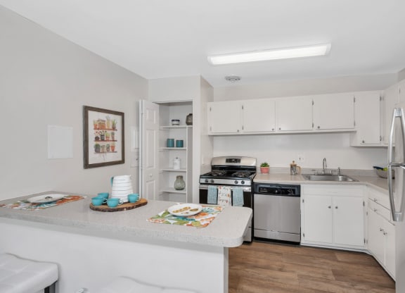 a kitchen with a counter top next to a stove top oven
