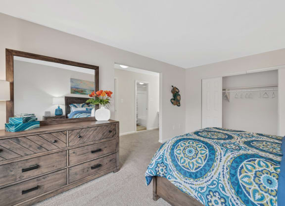 a bedroom with a bed and a dresser