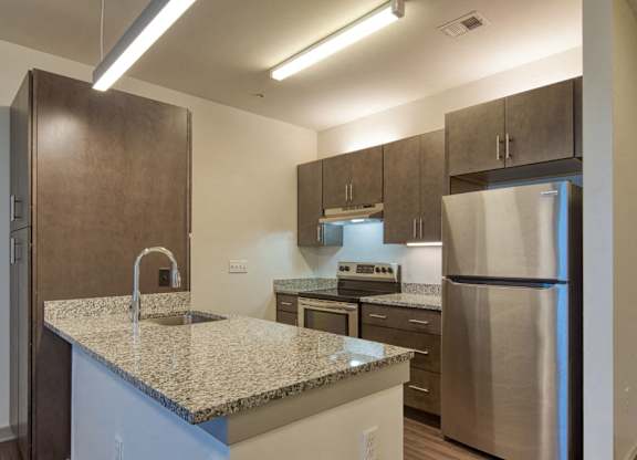 a kitchen with granite counter tops and stainless steel appliances