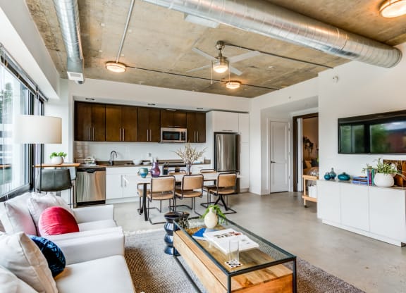 Modern apartment with kitchen, living room, and dining area.