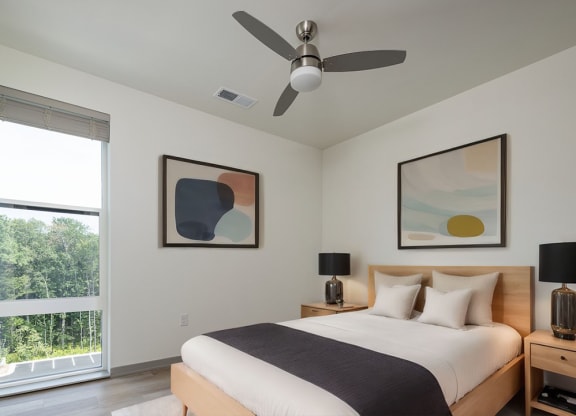 a bedroom with a bed and a ceiling fan