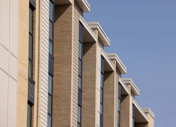 a brick building with windows against a blue sky