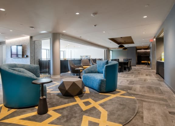 a lobby with couches and tables and chairs
