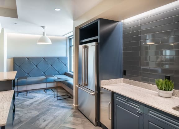 a kitchen with a stainless steel refrigerator and a counter top
