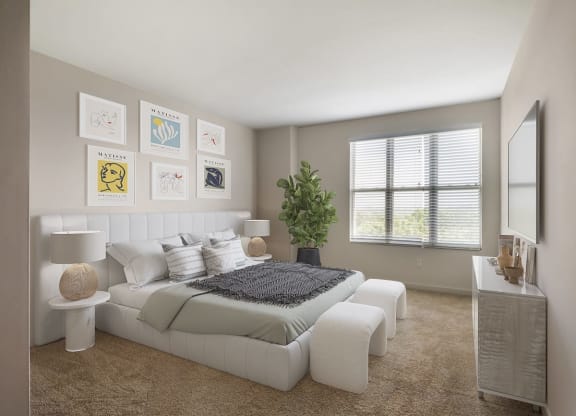 a white bedroom with a bed and a mirror
