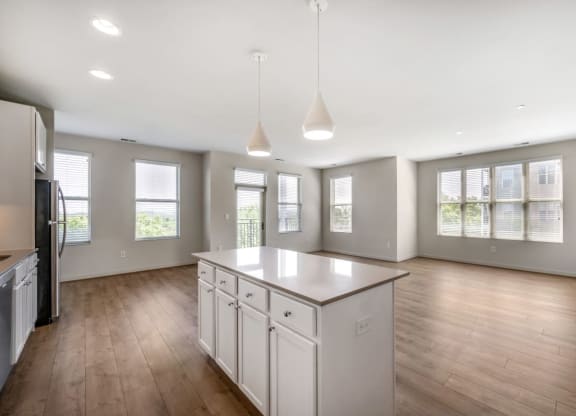 an empty kitchen with an island in the middle of it