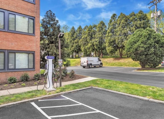 a white van parked in a parking lot next to a building