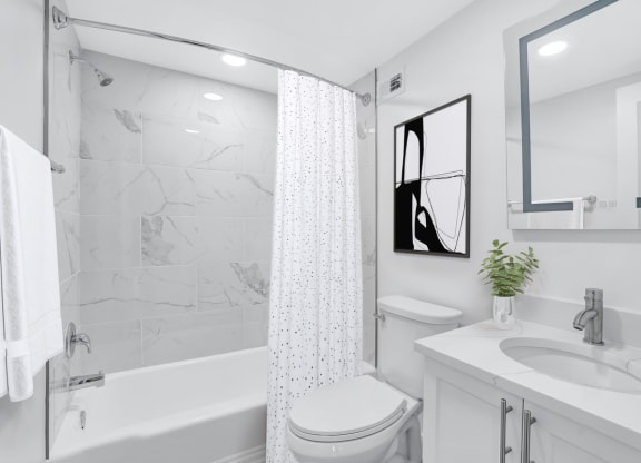 a white bathroom with a shower and a sink