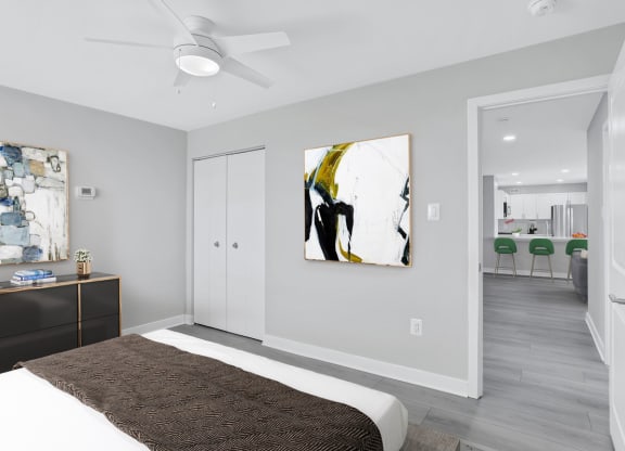 a bedroom with a bed and a ceiling fan