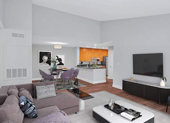 A furnished luxury apartment living room with large dining room and stylish kitchen in the background.