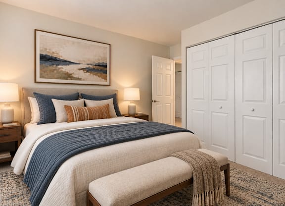 A bedroom with a large bed and a painting on the wall.