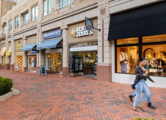a man walking down the street in front of a store