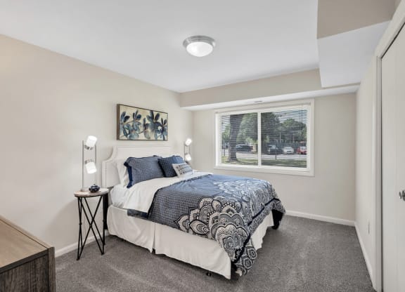a bedroom with a bed and a window