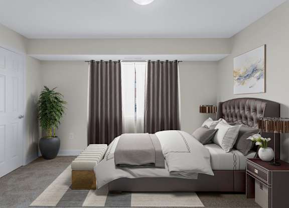 A bedroom with a large bed and a potted plant.