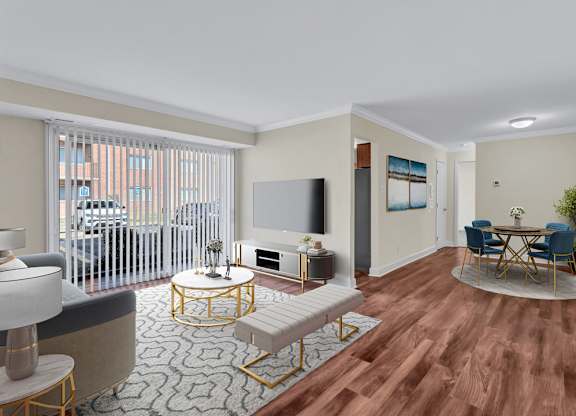 A living room with a television, a sofa, a chair, a table, and a potted plant.