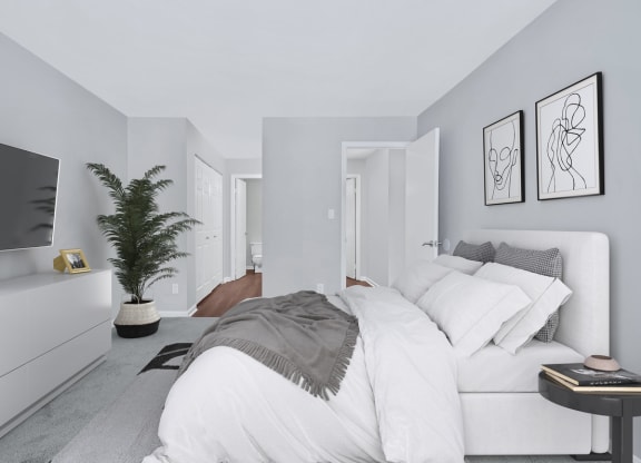 A sophisticated bedroom displaying a pristine white bed and a contemporary television.