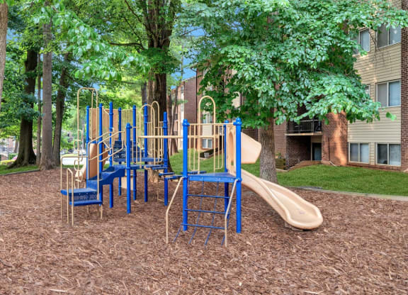 a playground with slides and chairs