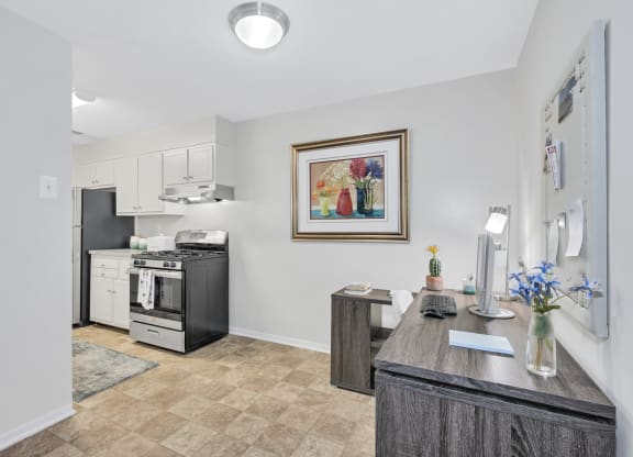a kitchen with a stove top oven next to a counter top with a vase of flowers