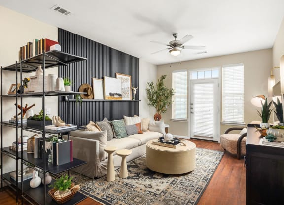 a living room with a white couch and a ceiling fan