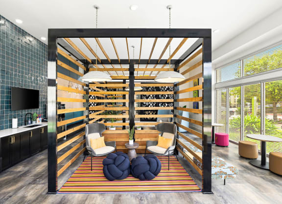 a living room with a wall of wine shelves and a table and chairs