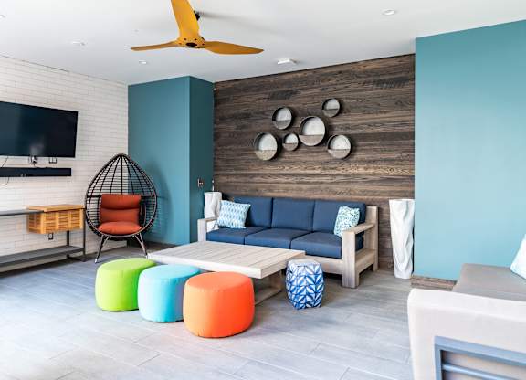 a living room with blue walls and colorful furniture