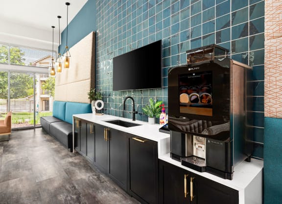 a kitchen with blue tiles and a coffee machine