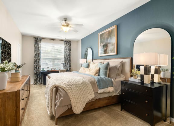 a bedroom with blue walls and a large bed