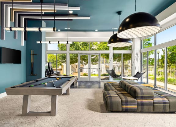 a billiards room with a pool table and couches